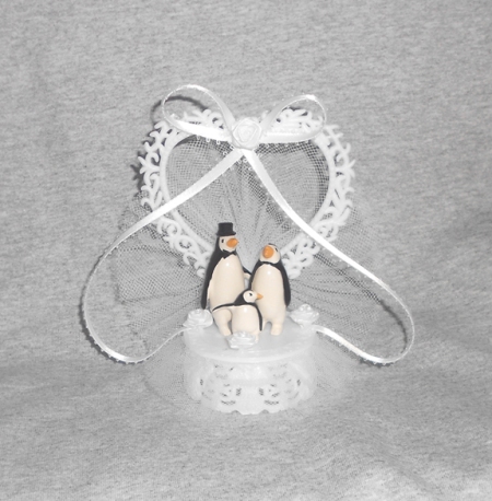 And baby makes a three penguin wedding cake topper